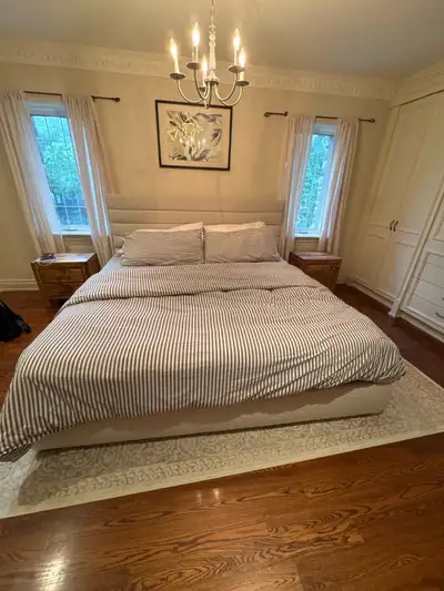 Upgrade your bedroom with this elegant queen-sized upholstered bed frame, which is in good pre-owned...