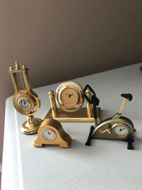 Set of four beautiful miniature mantle quartz golden clock.