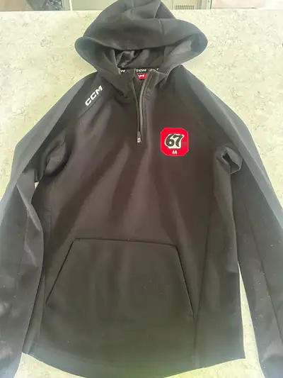 Good condition official OWHL Elite Ottawa 67's team merchandise hoodie by CCM. This sleek, modern ho...