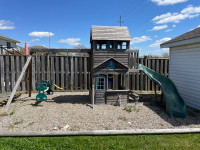 Swing set with playhouse and slide