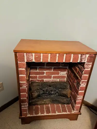 Nice wood decorative fireplace with electric logs!From a smoke free home!Reason for selling is I'm m...