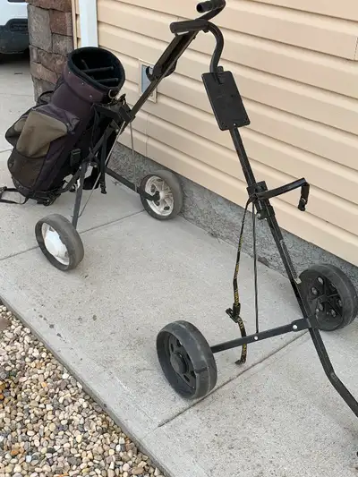 Push pull golf carts. Both in good used condition - one of the carts has a damaged yet still functio...