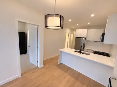 Enjoy bright, modern living in this top-floor home at The Audley. A private balcony with elevated vi...
