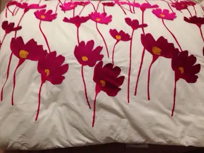 Queen sized embroidered quilt. White with fuchsia flowers. Comes with two standard size pillow cover...
