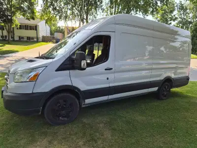 This 2015 Ford Transit campervan features a high-roof design and a professionally finished wood inte...