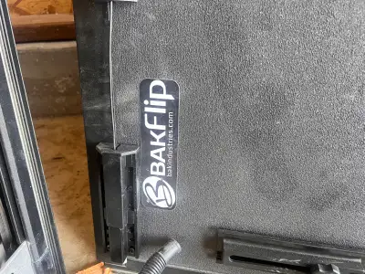 Tonneau cover for an F150 5.5 foot box. Bakflip In good condition Has a few minor dings Missing 1 dr...