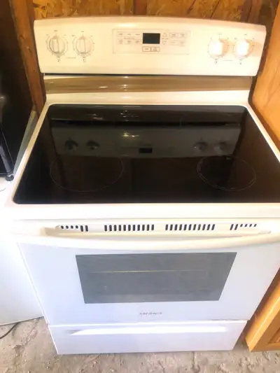 Amana range stove. Works great. The brown tape is just there to hold the electric cord in the back....