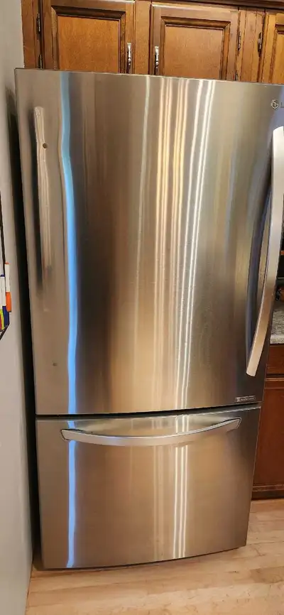 This LG bottom freezer refrigerator features a stainless steel finish, offering a 32.8-inch width, 3...