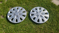 Two aluminum hubcaps. Wire diameter, 16 3/8 inches.