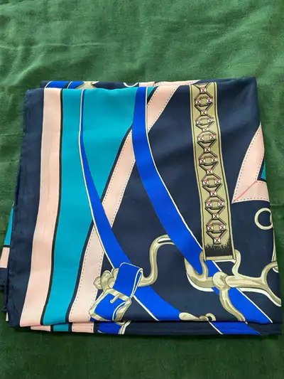 Enhance your accessory collection with this elegant blue and teal scarf, featuring a detailed equest...
