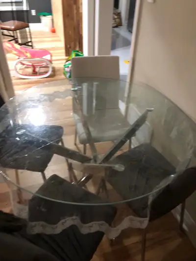 Almost new glass dining table set with four chairs and covers