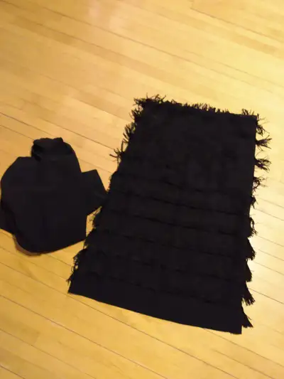 Black fringed material for a skirt Extra black material can. Be made into a top for skirt. Fringe mo...
