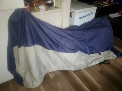 7 year old large motorcycle cover. Will fit Honda shadow with windshield. Reinforced tie down locati...