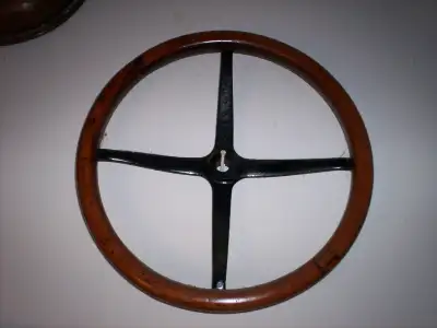 Two Antique Car Steering Wheels, View more