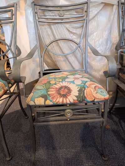 Table base and 4 chairs made of iron. Can be used inside or out. Currently chairs are covered in sun...