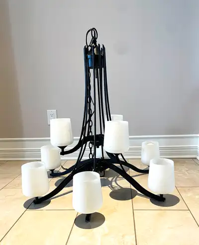 For sale is a very well-maintained 9-light, up chandelier. It is constructed from black wrought iron...