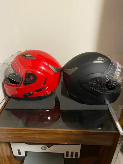 I'm offering two ILM motorcycle helmets, one in striking red and the other in sleek matte black, bot...
