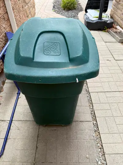 Large green Step2 storage bin/garbage can with hinged lid and wheels for easy moving. Some scuffs/sc...
