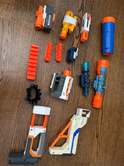 Three flashlights one suppressor three scopes, two stocks, two small Nerf bullet holders, one big Ne...