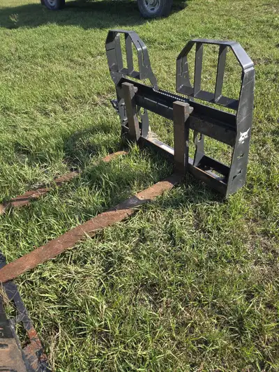 Forks bobcat heavey duty $1000 Snow bucket 8 wide 2500 Both barley used
