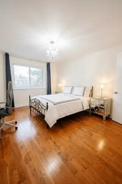 Cozy master bedroom with an attached private bathroom in a well-maintained detached house located in...