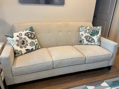 Beige Tufted Back Sofa with Floral Pillows, View more