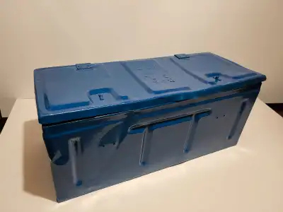 Large blue metal storage container. Shows some wear. Measures approximately 22 inches long. Hinged l...