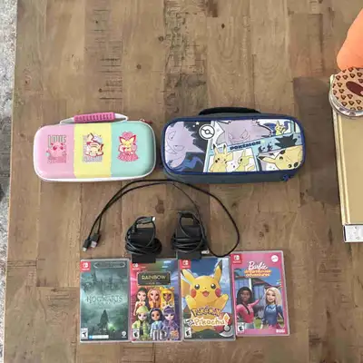 2x Nintendo switch Lite $150 each with Pokémon cases and games, View more