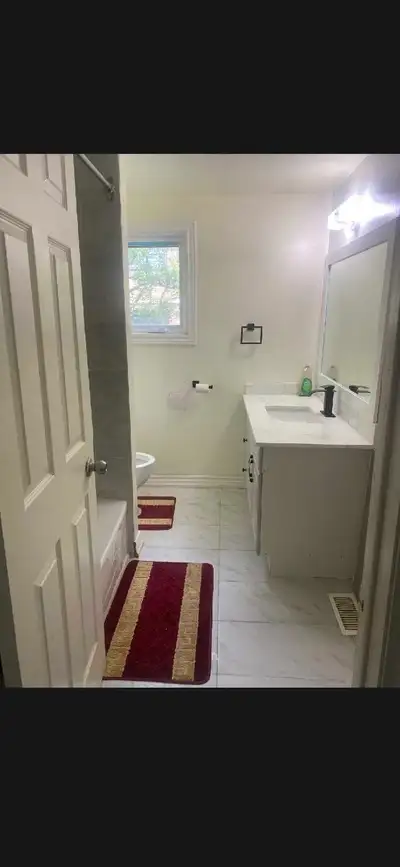 This spacious and bright shared room is available for rent, featuring updated flooring, modern light...