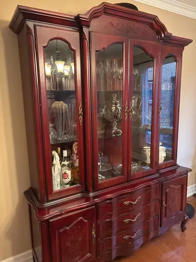 Beautiful wood display cabinet. Two pieces for easy movement. Light inside to enhance display. $150...