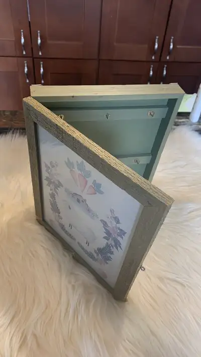 This is a wooden key cabinets with hanging hardware. Measures 11.5 x 9.5 x 1.5“ the inserts can be e...