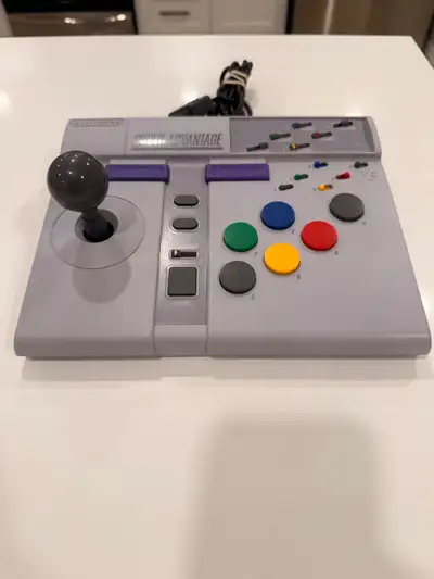 Classic Super Advantage arcade stick for your SNES. Has a cool joystick, all the colored buttons, an...