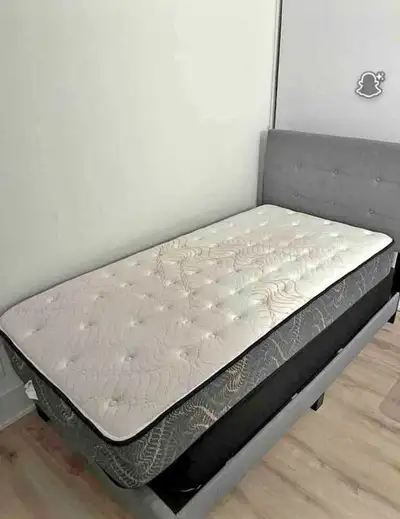 This single bed frame and mattress are available for sale; the mattress is in used condition, offeri...