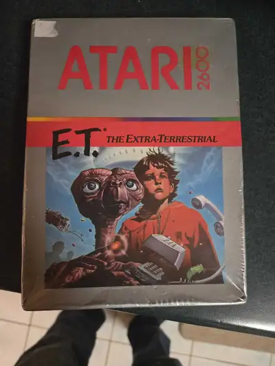 Relive a piece of gaming history with the Atari 2600 game, E.T. The Extra-Terrestrial! This vintage...