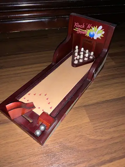 12” Miniature Wooden Bowling Alley. Complete with 10 wooden bowling pins and 2 ball bearing bowling...