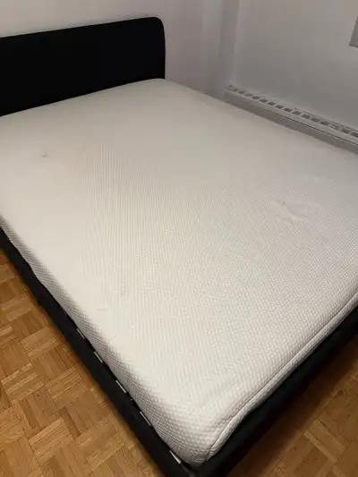 This queen size IKEA bed set includes both the modern, dark grey upholstered bed frame and the mattr...