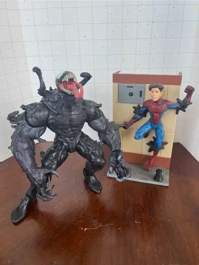 Adult collector, smoke-free home. Displayed in glass case but may have some dust. Includes Spider-ma...