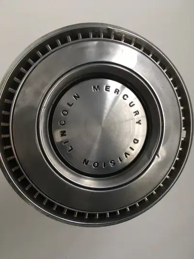 A perfect accent to any automotive decor. Aluminum vintage wheel cover. Some dents, but looks good f...