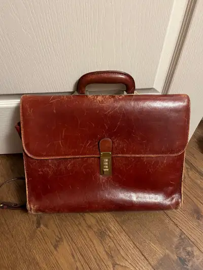 Beautiful cognac coloured briefcase - has some "loved" marks on it. Lock works well, and all zips/st...