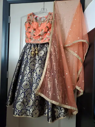 Beautiful orange top and and Navi blue and golden skrit. wear only once. I have matched jewellery al...