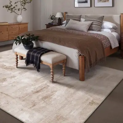 Enhance any decor with this 5' x 7' washable area rug finished in shades of lights creams, browns, t...