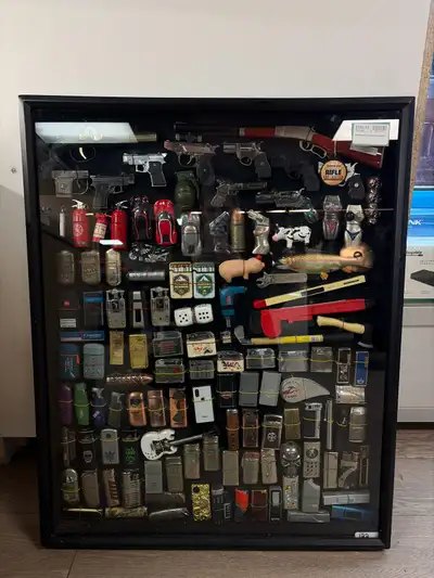 Zippo lighter collection in display case Some have fuel still Not selling separate, will not separat...