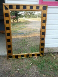 Mirror with gold and black painted wooden frame.
