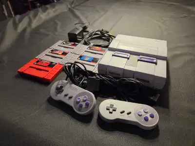 Super Nintendo (SNES) Bundle - Console, 2 Controllers, & 5 Classic Games Description: Relive the gol...