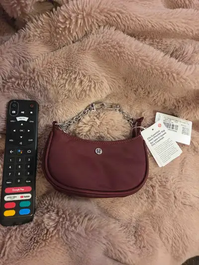 Brand new Lululemon City Essentials Nano Shoulder Bag in the rich Burgundy colorway, featuring a ver...