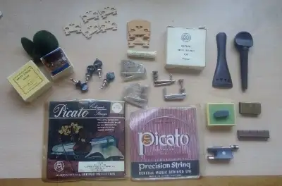Lots of goodies. E tuners, tailpieces, 3 resin boxed, set of Violin Pegs in box, violin bow stuff, b...