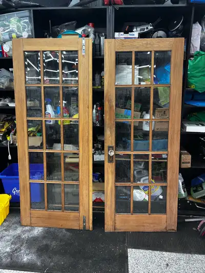 These are a pair of vintage cedar French doors, featuring beveled glass and unique crystal hardware....