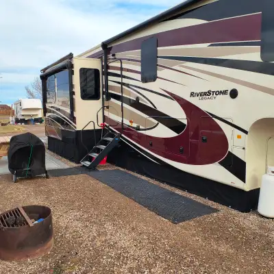 This 2nd owner full body painted fifth wheel offers a spacious layout with three slides and manageab...