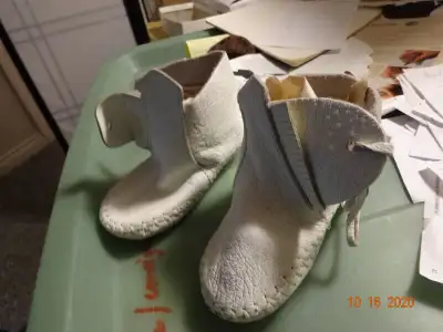 Baby shoes, mocassins by Minnetonka. white 6" long2.5"wide, View more