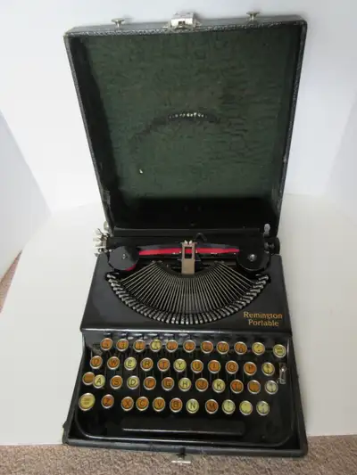 Antique Remington portable typewriter in carry case, estimated to be a 1920's model based on researc...